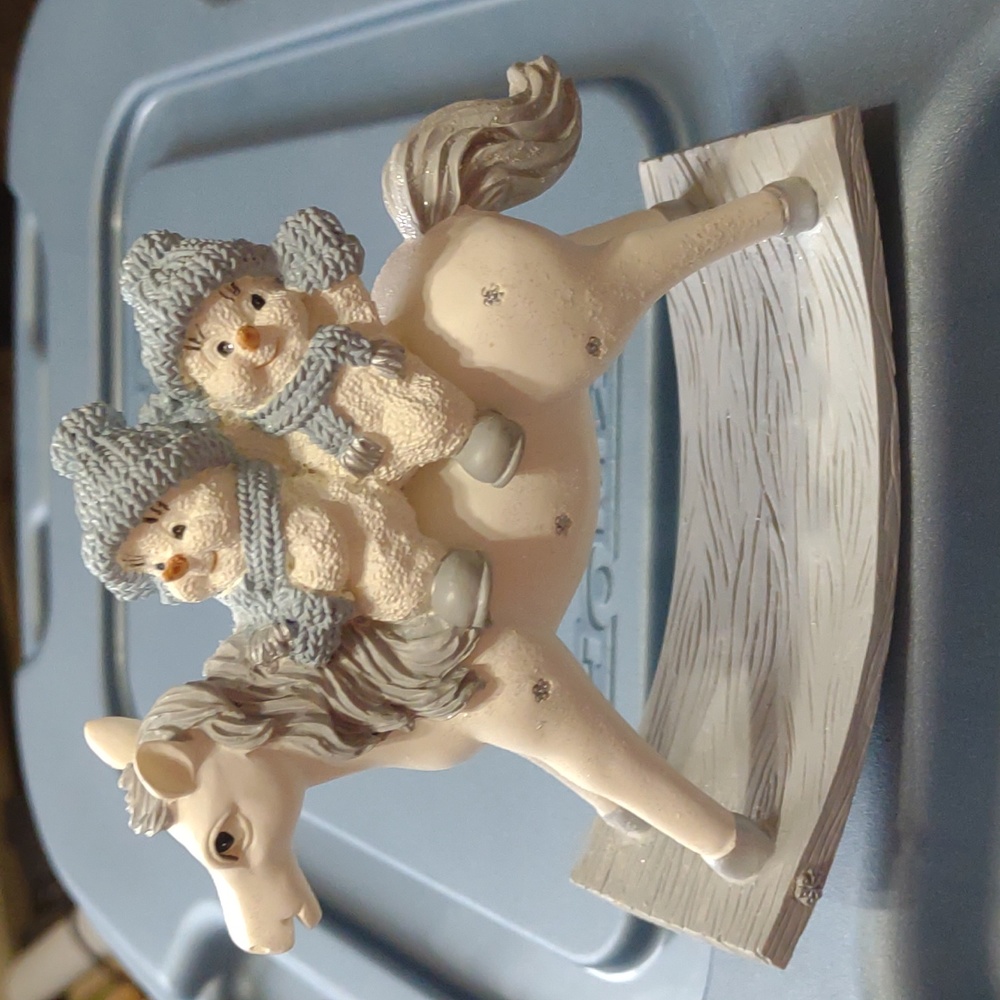 Vintage resin snow buddies on a rocking horse